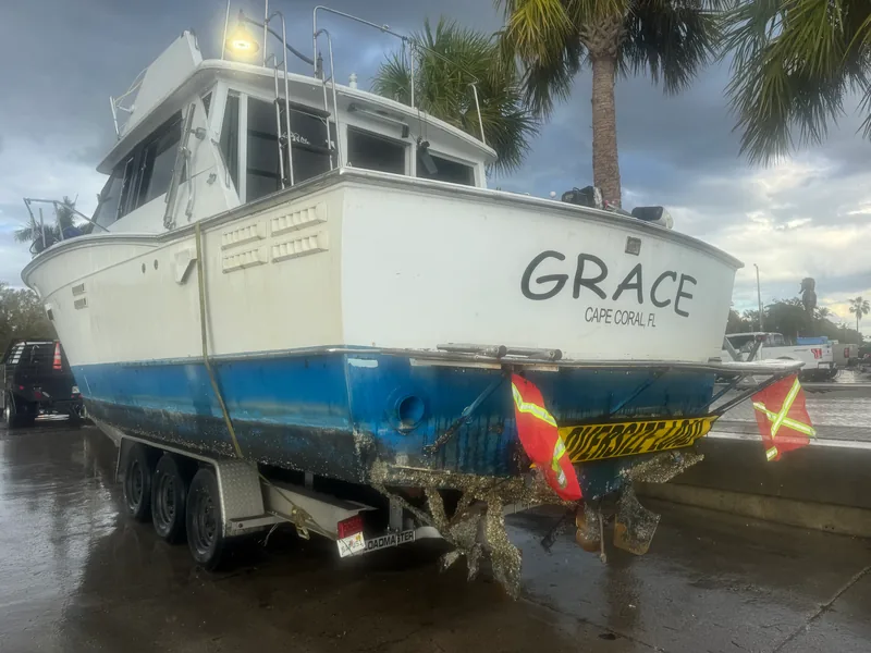 Excavator on a barge lifting a submerged vessel from the water