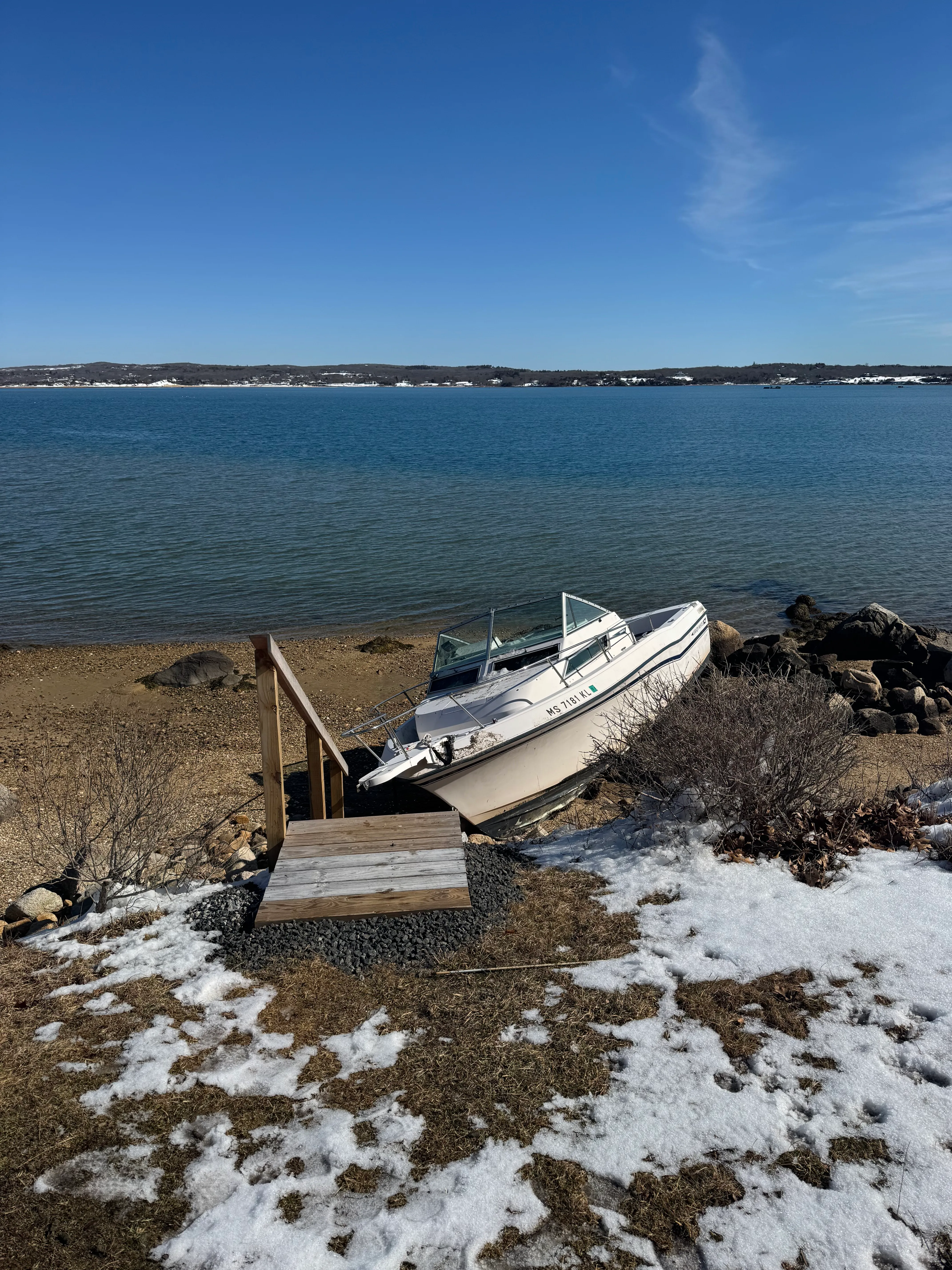 Captain Tom crew loading a cabin cruiser onto a trailer during a scheduled removal