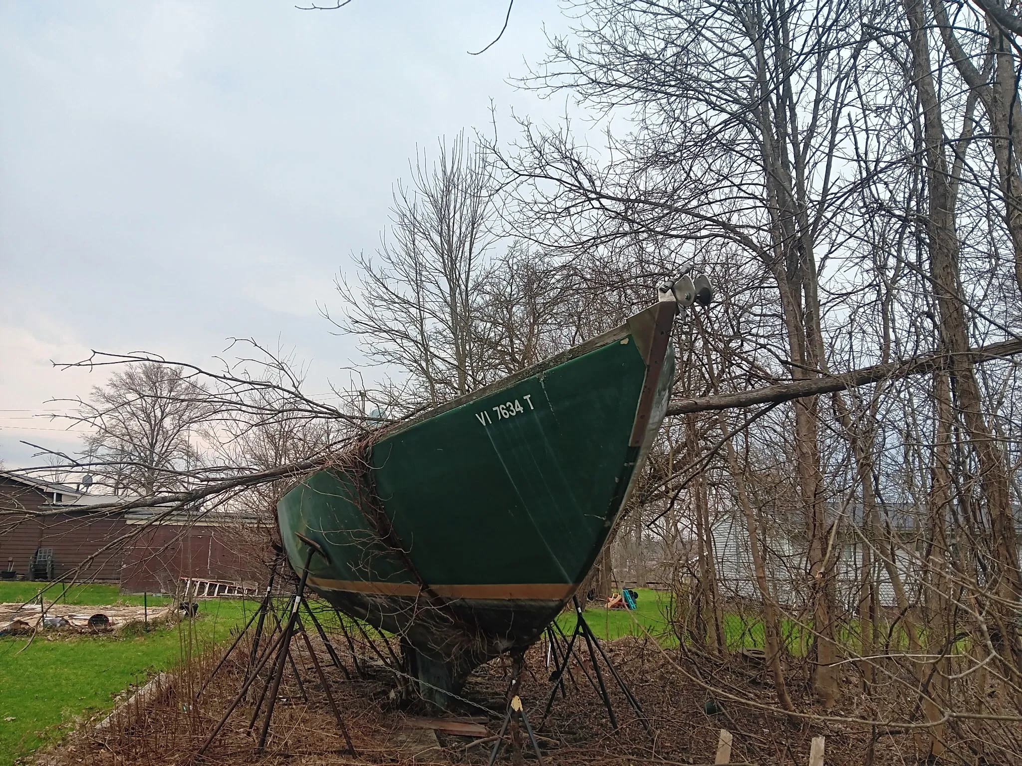 Derelict boat at marina inspected before the removal process