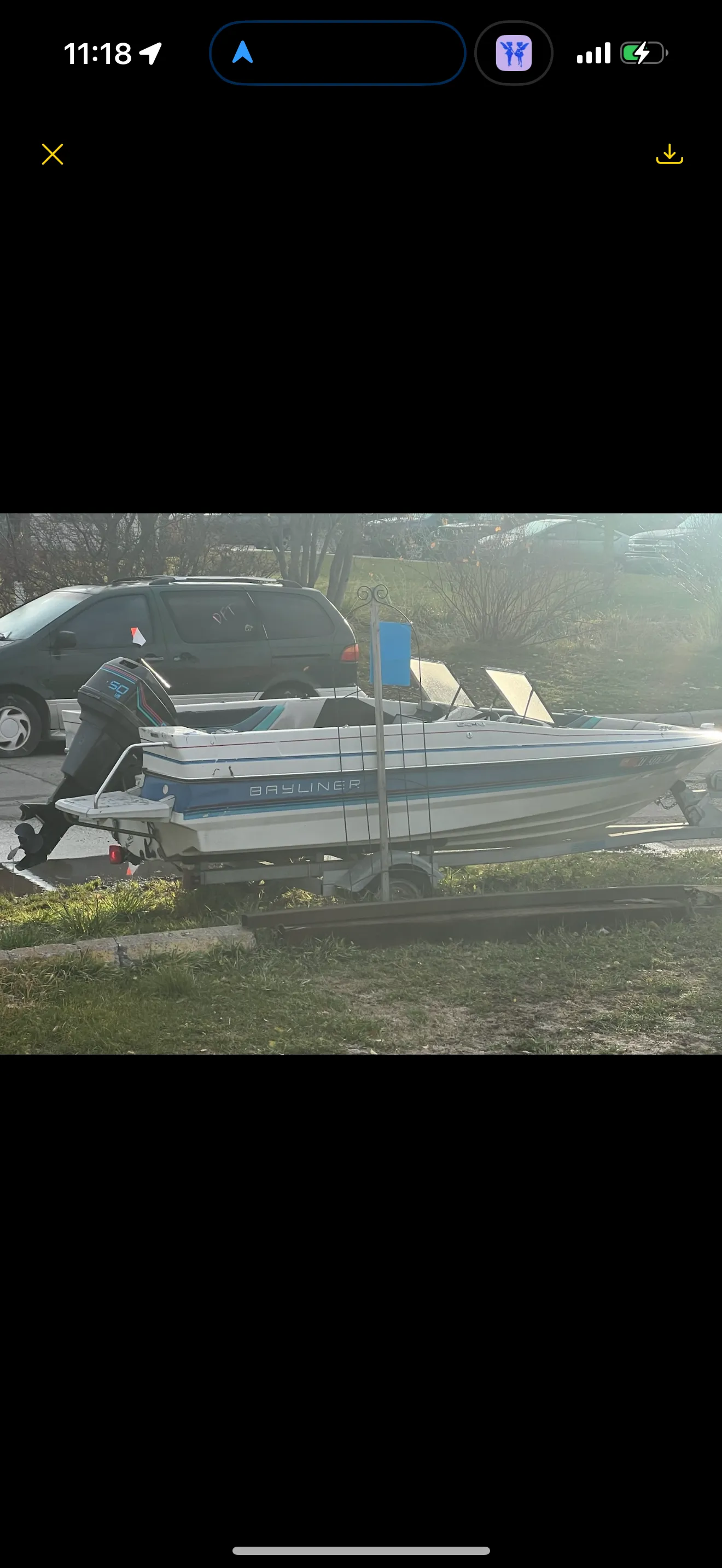 Small aluminum fishing boat being removed from a residential location