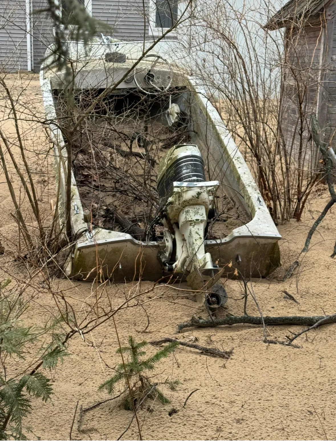 Sailboat near dock with mast prepared for disassembly and removal