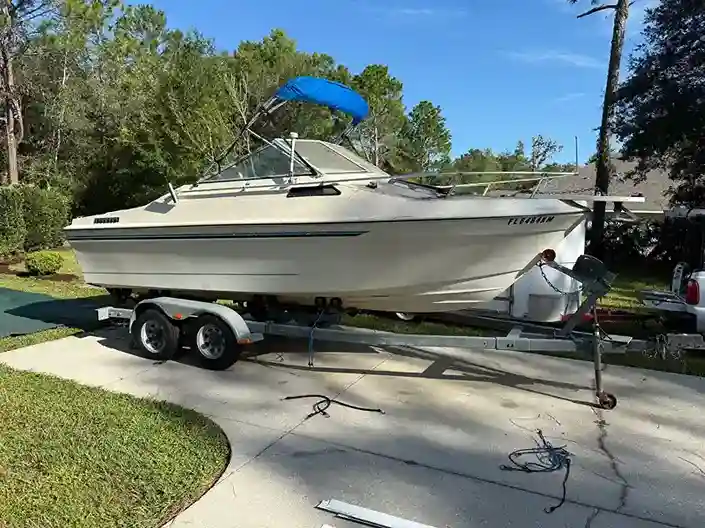 Boat tied at a waterfront dock photographed before a removal planning visit